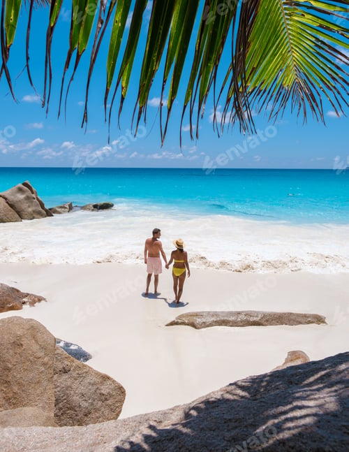 Preview: Anse Lazio Praslin Seychelles, a young couple of men and women on a tropical beach during vacation