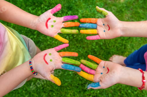 Preview: Hands of a child with a drawn smile. Selective focus.