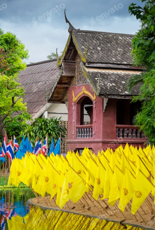 Preview: Yellow prayer flags in front of a wat temple, bright colours.