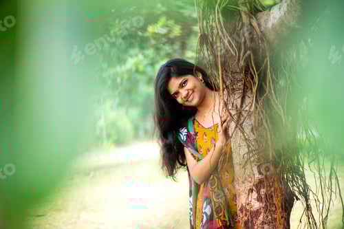 Preview: Happy woman near banyan tree