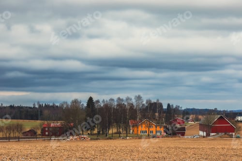 Preview: A tranquil Norwegian landscape featuring colorful farms under a moody sky