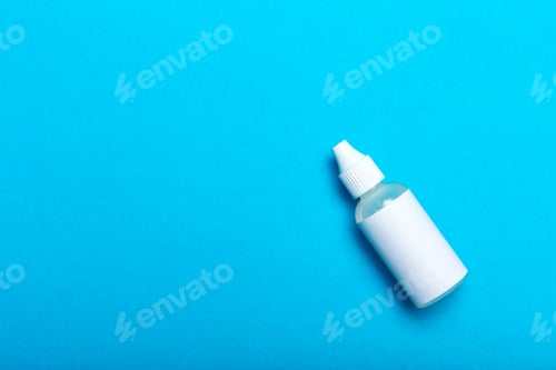 Preview: Clear bottle with a white cap on a solid blue background in a simple setting