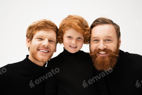 Preview: cheerful red haired boy with bearded grandfather and dad in black turtlenecks smiling at camera