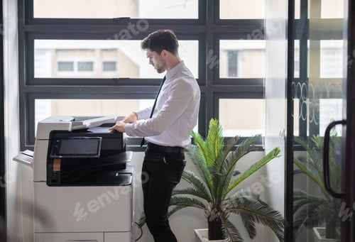Preview: Businessman Using Photocopier