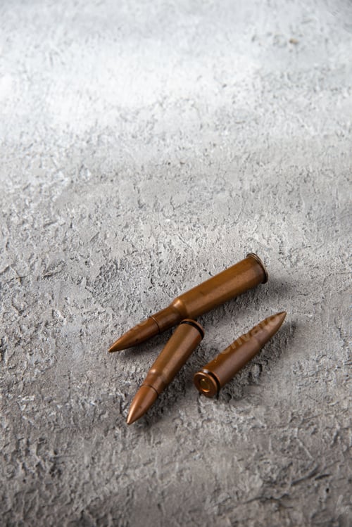 Preview: front view of brown bullets on a white surface tank war death soldier gun