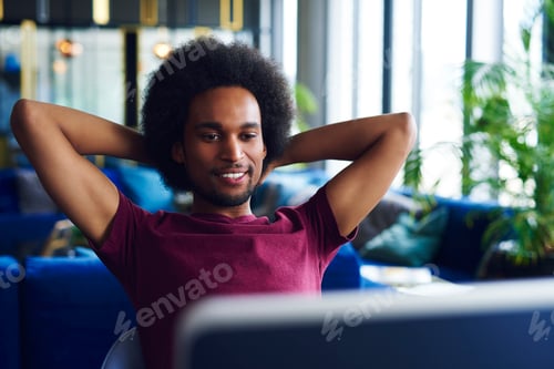 Preview: Young, african american man relaxing in the office