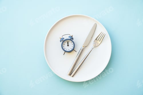 Preview: Intermittent fasting concept. Top view on blue.