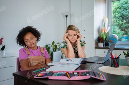 Preview: Stressed mother and bored daughter homeschooling at table