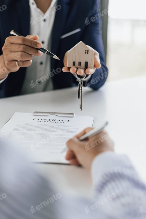 Preview: Real estate agent hands over the house keys to a homebuyer after the purchase agreement signed.