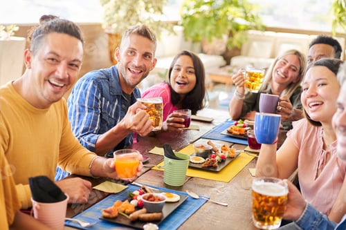 Preview: Happy group of friends drinking beer at brewery bar. Community concept on young people