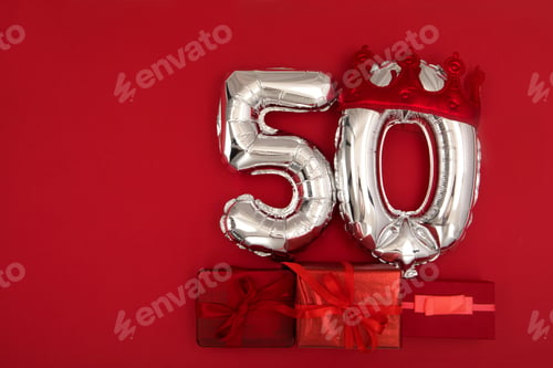Preview: Balloon 50 in crown on dark red background flat lay