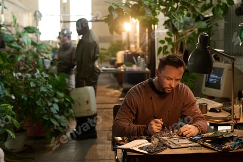 Preview: Man Repairing Device In Post-apocalyptic Shelter