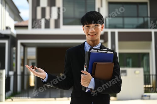 Preview: Handsome meal estate agent showing and presenting new house.