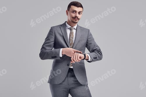 Preview: Portrait Of Handsome Young Confident Arabic Businessman With Fancy Mustache In Fashion Gray Full