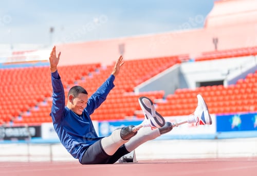 Preview: Sport man athlete with a prosthesis on his leg action of warm-up the body by lie down and rest arms
