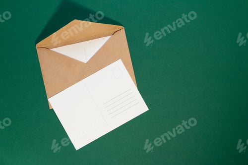 Preview: Empty greeting postcard with envelope on green background