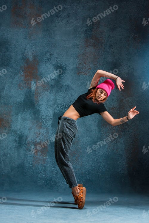 Preview: Young girl break dancing on wall background.