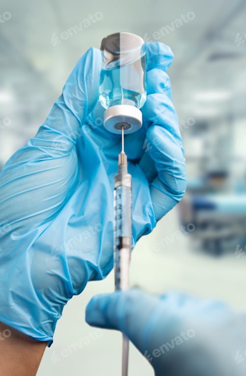 Preview: Doctor or Nurse Wearing Surgical Gloves Holding Vaccine Vial and Medical Syringe Within Hospital.