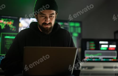 Preview: Hacker using laptop to organize malware attack on global scale. Copy space. Multiple screen.