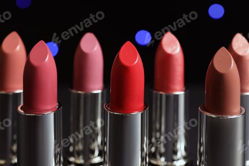 Preview: Different lipsticks against blurred lights. Cosmetic product