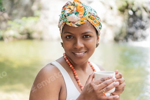 Preview: Hispanic Woman drinking coffee in the forest