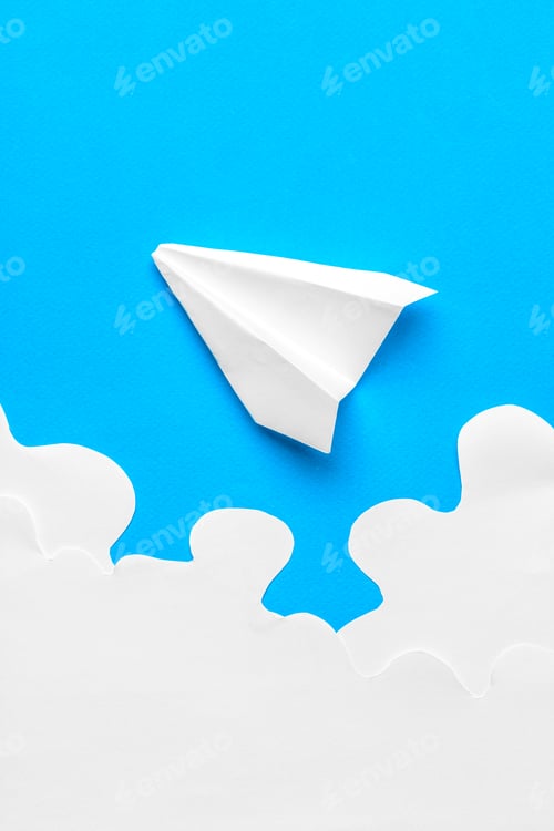 Preview: Flying paper plane in the clouds on a blue background. Concept of flight, travel, transfer