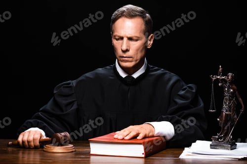 Preview: judge in judicial robe holding gavel and putting hand on book isolated on black
