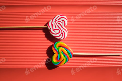 Preview: Two lollipops sitting on a red background