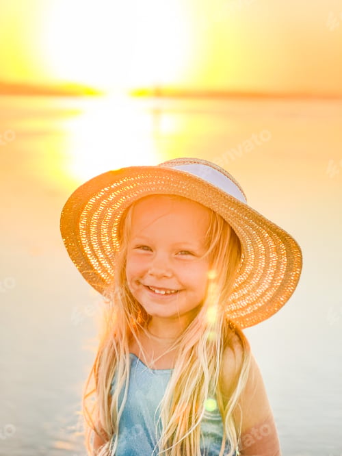 Preview: Smiling Girl in Straw Hat at Golden Sunset