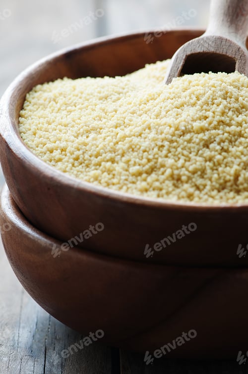 Preview: Uncooked couscous on the wooden table