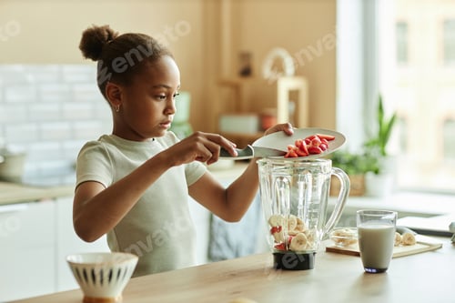 Preview: African American Girl Making Smoothie on Kitchen Counter