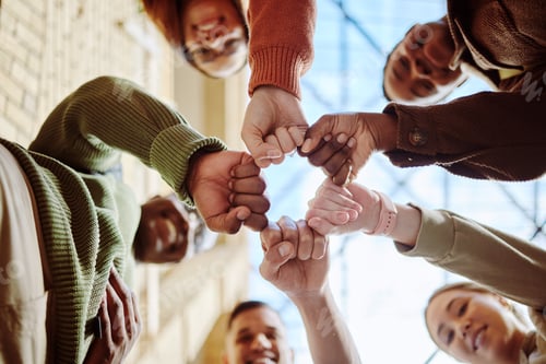 Preview: Below, students and fist hands in group for support, motivation or education in sunshine at college