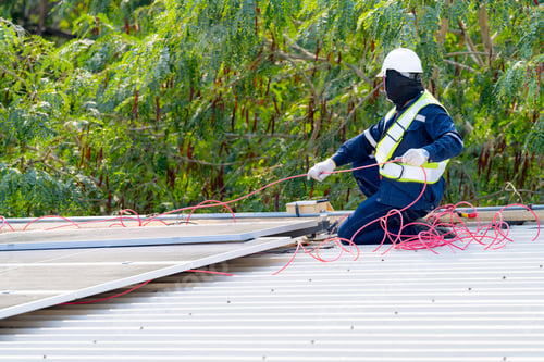 Preview: workers installing solar panels, for efficient energy on rooftop