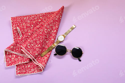 Preview: Stylish handkerchief, wristwatch and sunglasses on violet background, flat lay. Space for text