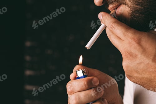 Preview: Bearded man lighting cigarette with fire lighter