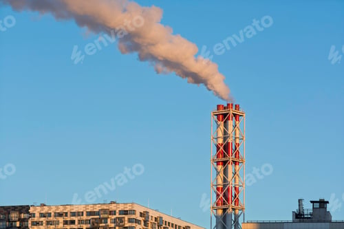 Preview: Residential boiler house chimney emits warm vapor above modern housing block