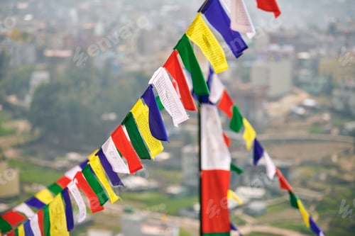 Preview: Colorful Tibetan prayer flags on blurred Kathmandu cityscape background