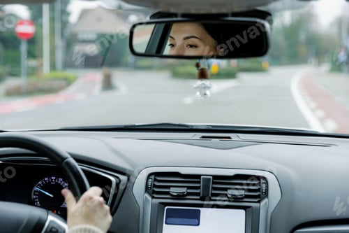 Preview: Beautiful woman driver driving a car during the day.