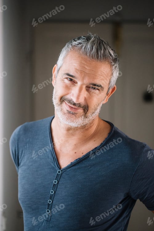 Preview: Portrait of smiling mature man at home