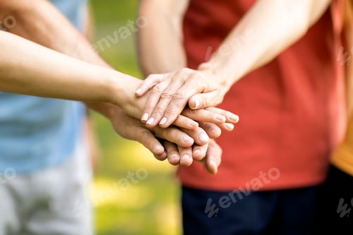 Preview: Unity Concept. Group Of Mature People Joining Hands Together While Standing Outdoors