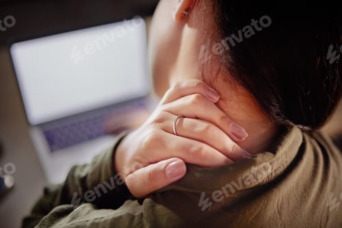 Preview: Neck pain, hand and woman with closeup at desk with laptop, stiff joint with injury and hurt. Burno