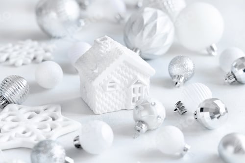 Preview: White toy house with white and silver Christmas decorations closeup