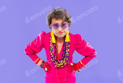 Preview: Happy and funny senior old woman on colorful background