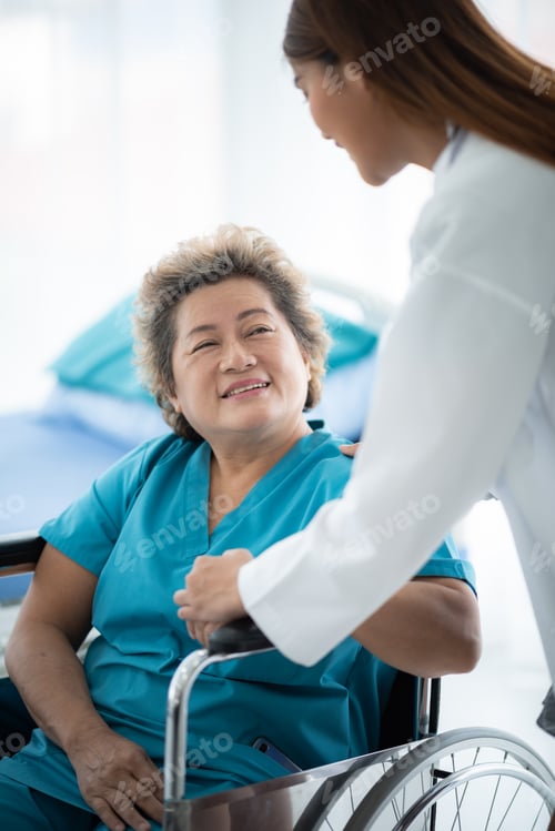 Preview: Smiling young female doctor checking and measuring blood pressure of senior patient