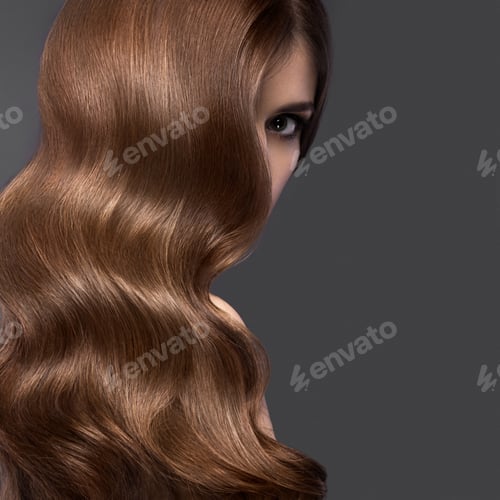 Preview: Beautiful brunette girl with a perfectly curls hair and classic make-up. Beauty face.