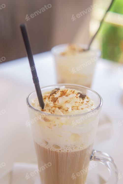 Preview: coffee is served in a tall glass glass with a straw. The concept of coffee drinks from the bar menu