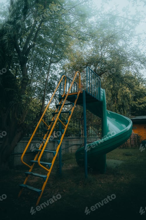 Preview: Playground with a slide, surrounded by lush green grass