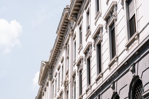 Preview: ornate white building facade with tall windows and columns