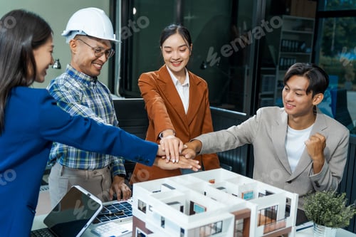 Preview: architect-engineer team discusses modern house model at desk. They review renovation project.