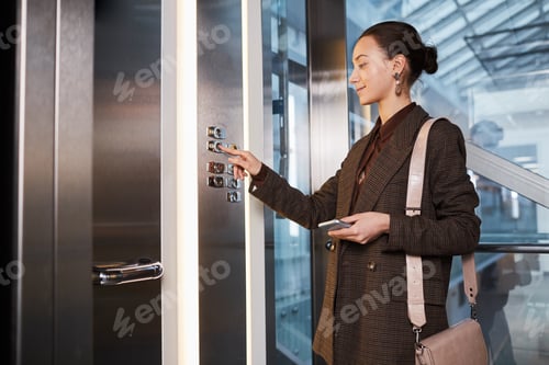 Preview: Young Businesswoman in Elevator